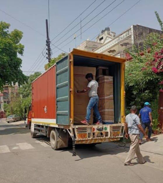Moving truck being loaded with household goods during a house shifting job