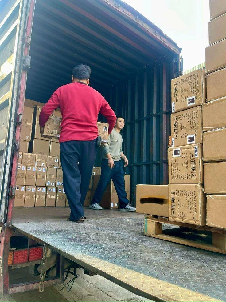 Movers stacking cartons inside a goods truck for local and intercity moving